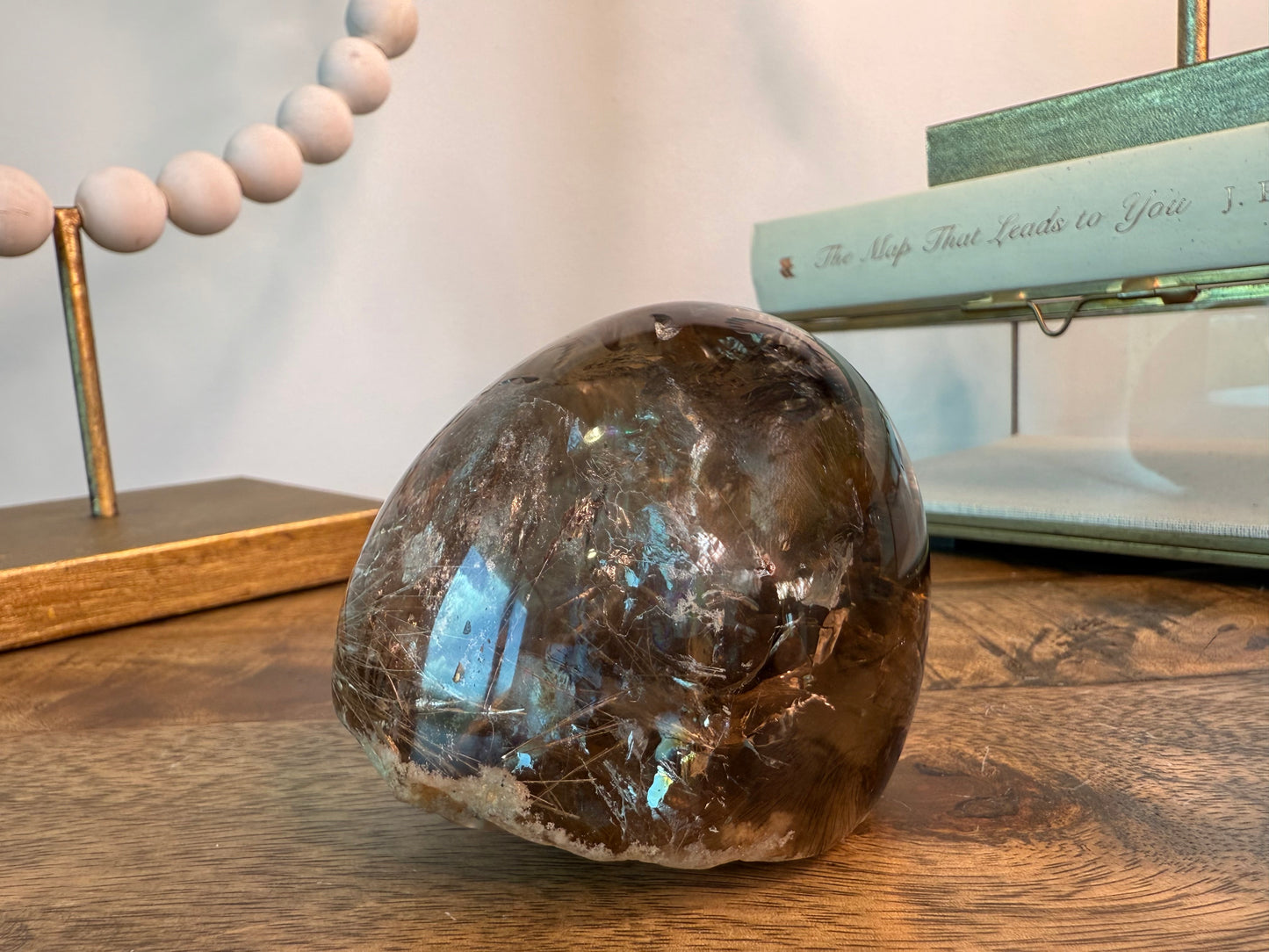 Smoky quartz sphere with beige rutile lodolite and rainbows